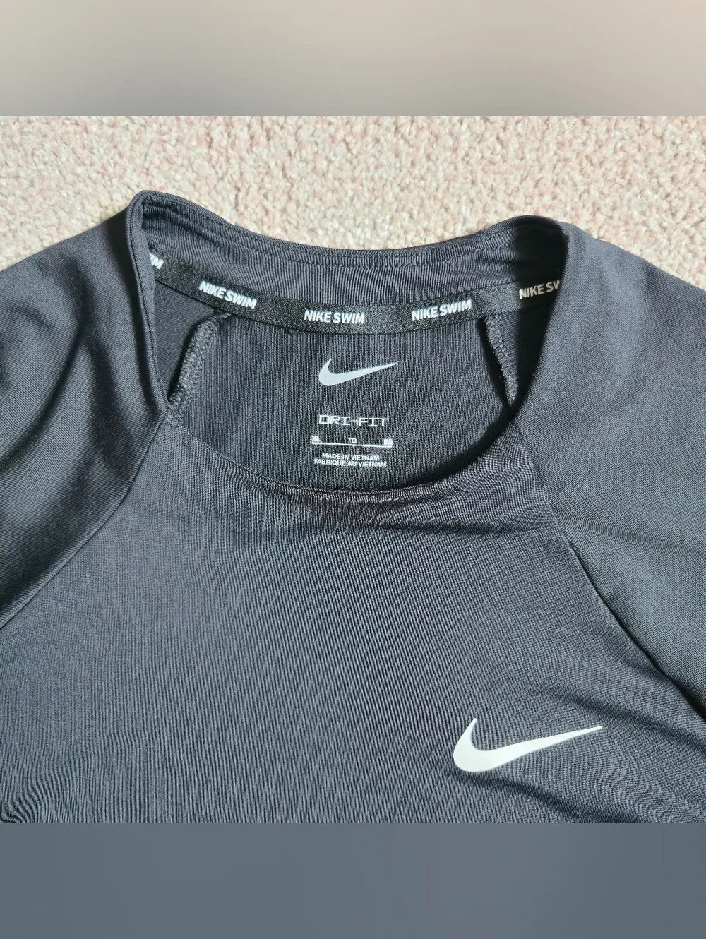 Nike Swim Dri-FIT long-sleeve Rashguard features a classic athletic crewneck